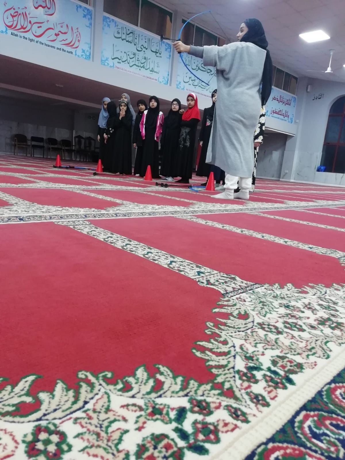 Girls and women trying archery in the mosque
